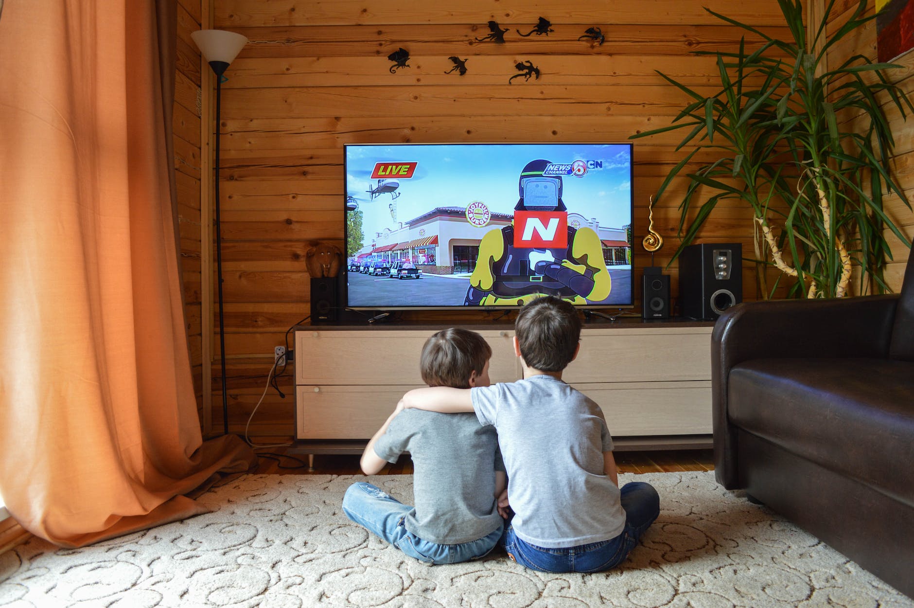 faceless little boys entertaining with tv at home