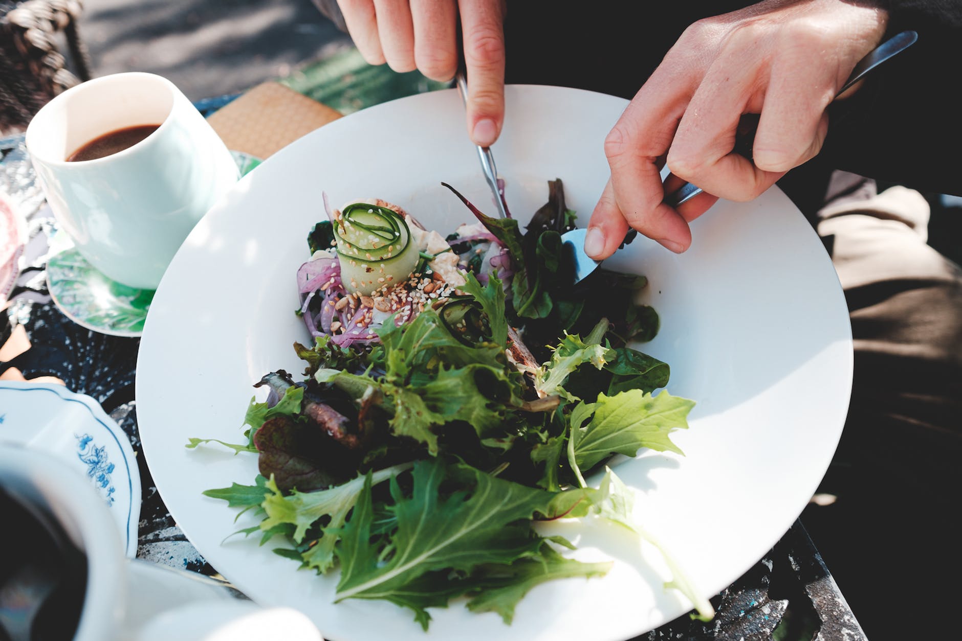 crop unrecognizable man eating fresh mix leaves salad